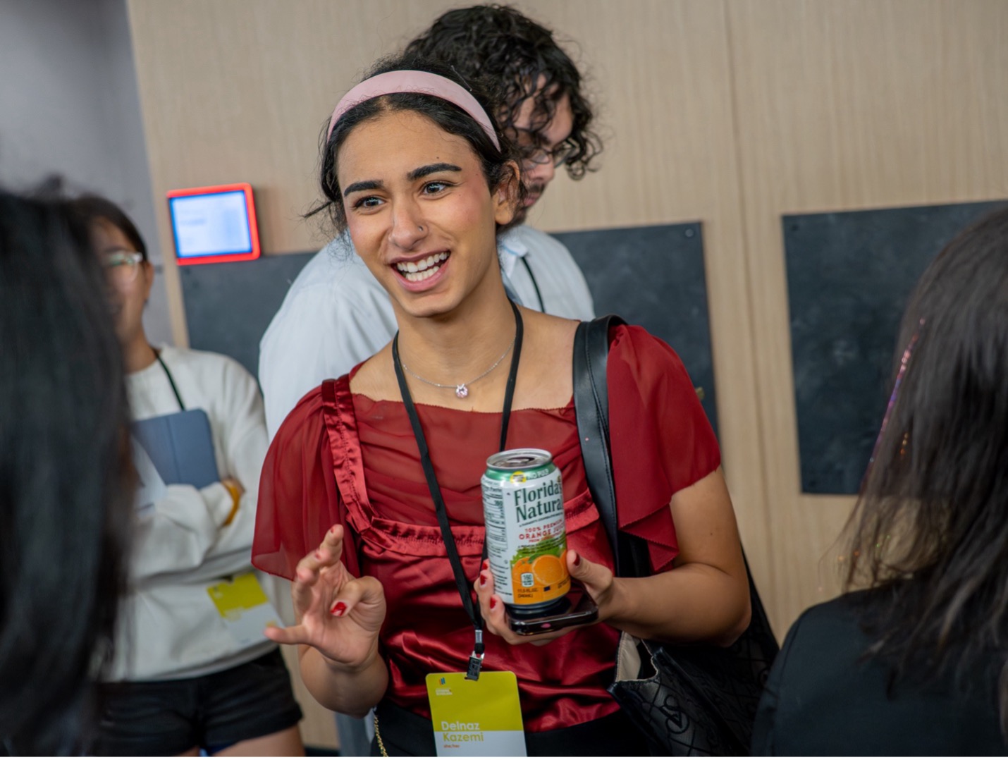 woman talking and holding a drink