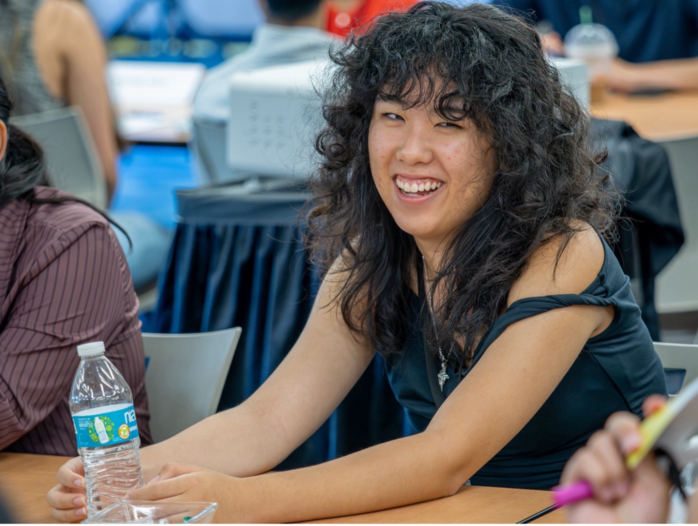 person smiling holding a water bottle