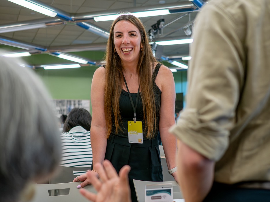 woman standing over a table smiling
