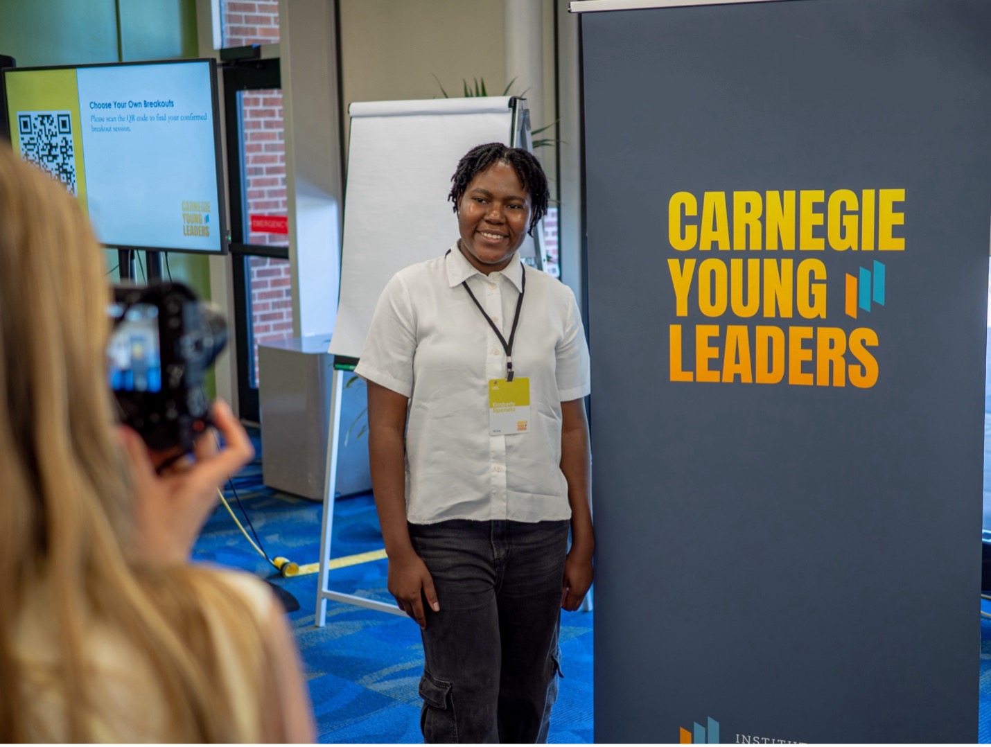 person standing next to a sign