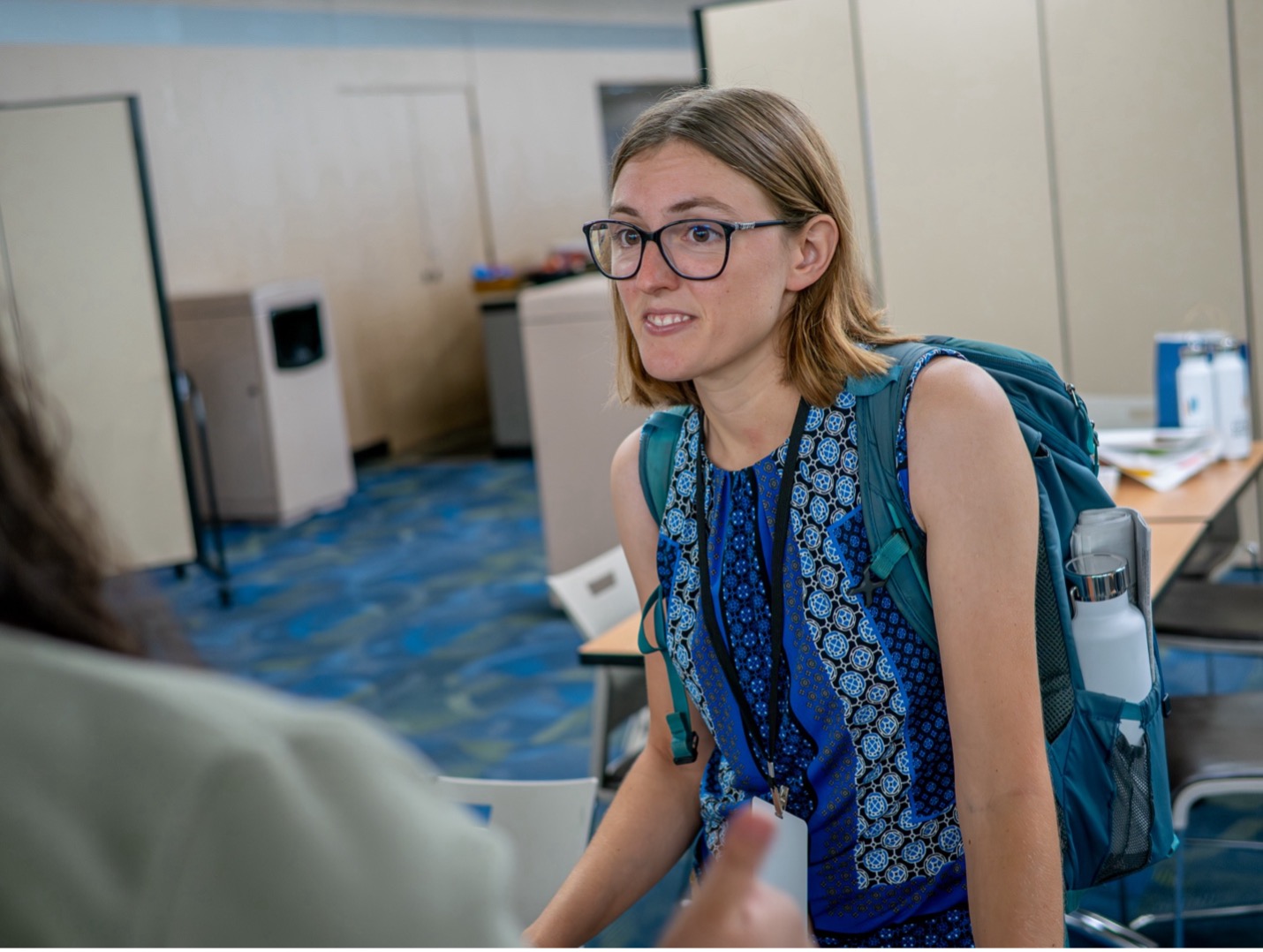 young woman with glasses wearing a bookbag