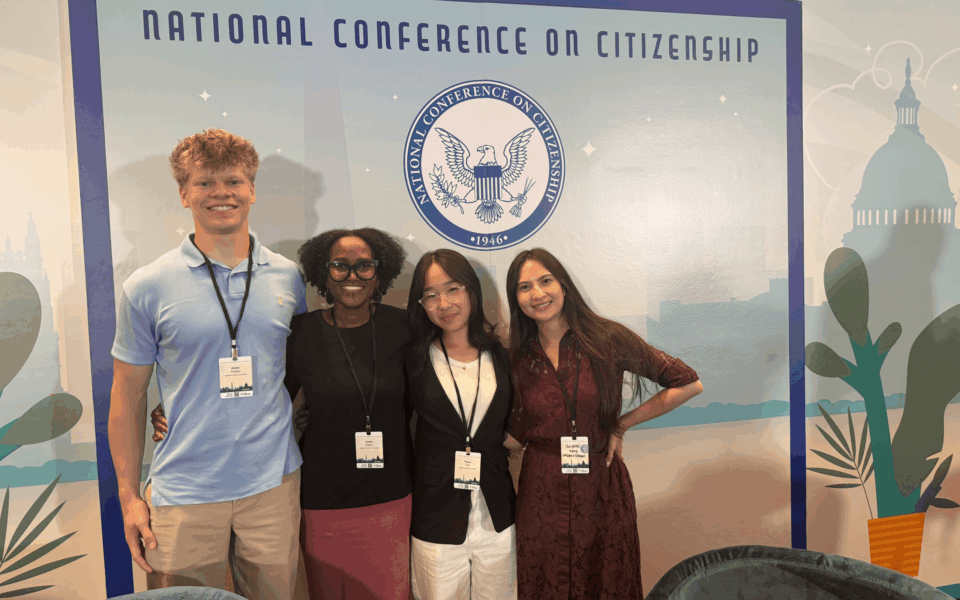 Group of people standing together smiling